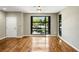 Living room with hardwood floors, ceiling fan, neutral paint, and a large window overlooking the neighborhood at 472 Martin Se St # 10, Atlanta, GA 30312
