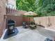 Cozy backyard featuring a grill, outdoor furniture, privacy fence, and a lush green surrounding landscape at 5605 Waters Edge Trl, Roswell, GA 30075