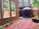 Cozy backyard featuring a private patio with umbrella, seating, and brick-lined garden at 5605 Waters Edge Trl, Roswell, GA 30075