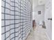 Bathroom with a shower/tub and a white and blue shower curtain. The toilet is visible and the walls are painted light grey at 5605 Waters Edge Trl, Roswell, GA 30075