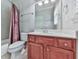 Bathroom featuring a wooden vanity, sink, mirror, and a shower with a decorative curtain, and tiled floors at 5605 Waters Edge Trl, Roswell, GA 30075