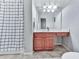 Bathroom with a vanity, a white and blue shower curtain, mirror, sink and fixtures, and tile floors at 5605 Waters Edge Trl, Roswell, GA 30075