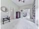 Large bonus room featuring neutral carpets, varied furniture, custom bookshelves, and access to other rooms at 5605 Waters Edge Trl, Roswell, GA 30075