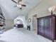 Large bonus room featuring neutral carpets, varied furniture, and an open doorway to a private bathroom at 5605 Waters Edge Trl, Roswell, GA 30075