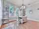 Bright dining area with wood floors, modern chandelier, and shelving display case at 5605 Waters Edge Trl, Roswell, GA 30075