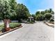 Gated entrance to a private property, with mature trees and manicured landscaping at 5605 Waters Edge Trl, Roswell, GA 30075