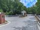 Gated community entrance with well-maintained landscaping and a security gate for added privacy and security at 5605 Waters Edge Trl, Roswell, GA 30075