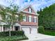 Charming brick townhome featuring a two-car garage and beautiful landscaping at 5605 Waters Edge Trl, Roswell, GA 30075