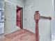Hallway showcasing hardwood floors, white railings, and an open doorway that reveals an elevator at 5605 Waters Edge Trl, Roswell, GA 30075