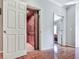 Hallway featuring access to a wood-paneled elevator and an additional room at 5605 Waters Edge Trl, Roswell, GA 30075