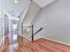 Bright hallway with rich hardwood floors and staircase with dark wood accents at 5605 Waters Edge Trl, Roswell, GA 30075