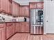 Well-equipped kitchen boasts stainless steel refrigerator and custom cabinetry at 5605 Waters Edge Trl, Roswell, GA 30075