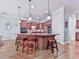 Open kitchen features an island, pendant lights, and stainless steel appliances at 5605 Waters Edge Trl, Roswell, GA 30075