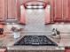Elegant gas range with custom tile backsplash and granite countertops for refined cooking at 5605 Waters Edge Trl, Roswell, GA 30075