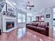 Living room featuring a fireplace, hardwood floors, and kitchen views at 5605 Waters Edge Trl, Roswell, GA 30075