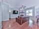 Inviting living room with hardwood floors, fireplace, ceiling fan, and large screen tv at 5605 Waters Edge Trl, Roswell, GA 30075