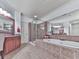 Elegant main bathroom with large tub, shower, and wood cabinetry at 5605 Waters Edge Trl, Roswell, GA 30075