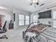 Spacious bedroom with a large window, TV, neutral carpeting, and a comfortable, stylish bed with warm accents at 5605 Waters Edge Trl, Roswell, GA 30075