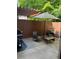 Private outdoor patio featuring a grill, seating under a pergola, and a sun umbrella at 5605 Waters Edge Trl, Roswell, GA 30075
