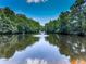 Scenic view of the community pond with a fountain, surrounded by lush greenery at 5605 Waters Edge Trl, Roswell, GA 30075