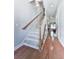 Staircase with hardwood floors and neutral walls at 5605 Waters Edge Trl, Roswell, GA 30075
