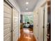 Hallway featuring hardwood floors leading into the living room with ample closet space on the left at 1080 Peachtree Ne St # 608, Atlanta, GA 30309