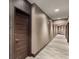 Modern condo hallway with textured walls, carpet flooring, and a wooden front door at 1080 Peachtree Ne St # 608, Atlanta, GA 30309