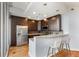 Modern kitchen with stainless steel appliances, dark wood cabinetry, and a breakfast bar with seating at 1080 Peachtree Ne St # 608, Atlanta, GA 30309