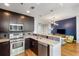 Modern kitchen equipped with stainless steel appliances, granite countertops, and a view into the living area at 1080 Peachtree Ne St # 608, Atlanta, GA 30309