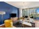 Living room with comfortable seating, modern lighting, and a beautiful view of the city at 1080 Peachtree Ne St # 608, Atlanta, GA 30309