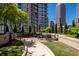 Outdoor patio space with tables, chairs, umbrellas, and manicured landscaping, ideal for relaxing or entertaining guests at 1080 Peachtree Ne St # 608, Atlanta, GA 30309