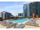 Luxury rooftop pool featuring stylish lounge chairs, umbrellas, and beautiful views of the cityscape at 1080 Peachtree Ne St # 608, Atlanta, GA 30309