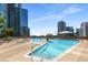 Rooftop pool deck with inviting lounge chairs and umbrellas; a perfect retreat with city views at 1080 Peachtree Ne St # 608, Atlanta, GA 30309