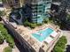 Aerial view of rooftop pool with lounge chairs and trees, set atop a modern building at 1080 Peachtree Ne St # 608, Atlanta, GA 30309