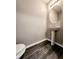 Stylish powder room featuring a pedestal sink, elegant mirror, and modern fixtures at 2533 Piering Dr, Lithonia, GA 30038