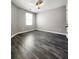 This bedroom is complete with wood-look floors and a window to let in natural light at 2533 Piering Dr, Lithonia, GA 30038