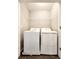 Bright laundry room equipped with modern appliances and a wire shelf for storage at 2533 Piering Dr, Lithonia, GA 30038