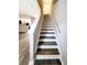 A staircase featuring hardwood treads and white risers, providing access to upper levels at 2533 Piering Dr, Lithonia, GA 30038