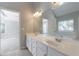 Bathroom with dual vanities, a soaking tub, and a view into the bedroom at 2687 Mountain Oaks Ct, Powder Springs, GA 30127