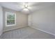 Neutral carpeted bedroom with a ceiling fan and natural light at 2687 Mountain Oaks Ct, Powder Springs, GA 30127