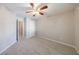 Bedroom featuring new carpet, a ceiling fan, and a door to the hallway at 2687 Mountain Oaks Ct, Powder Springs, GA 30127