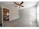 Neutral bedroom with ceiling fan, carpeting, and a view of the upstairs hallway at 2687 Mountain Oaks Ct, Powder Springs, GA 30127