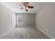 A neutral bedroom offers a ceiling fan and plush carpet at 2687 Mountain Oaks Ct, Powder Springs, GA 30127