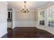 Formal dining room featuring hardwood floors, wainscoting, a chandelier, and a bay window at 2687 Mountain Oaks Ct, Powder Springs, GA 30127