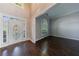 Sunlit entryway with decorative glass door, sidelights, transom, and gleaming hardwood floors at 2687 Mountain Oaks Ct, Powder Springs, GA 30127