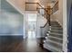 Elegant foyer showcasing a staircase with wrought iron railings and dark hardwood flooring at 2687 Mountain Oaks Ct, Powder Springs, GA 30127