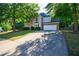 Charming two-story home with stone accents, manicured landscaping, and a long driveway at 2687 Mountain Oaks Ct, Powder Springs, GA 30127