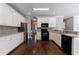 Bright kitchen featuring white cabinets, dark hardwood floors, and stainless steel appliances at 2687 Mountain Oaks Ct, Powder Springs, GA 30127