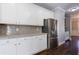 Bright kitchen featuring white cabinets, stainless steel refrigerator, and granite countertops at 2687 Mountain Oaks Ct, Powder Springs, GA 30127