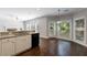 Open kitchen with granite countertops, black appliances, and an adjacent dining area at 2687 Mountain Oaks Ct, Powder Springs, GA 30127